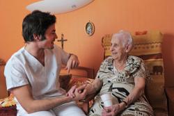 elderly woman talking with a caretaker
